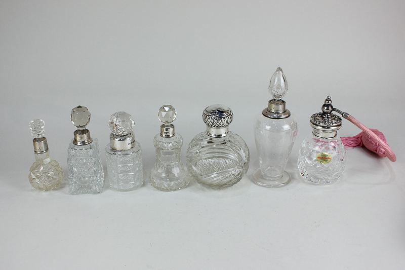 A collection of seven George V and later silver mounted cut glass scent bottles