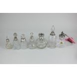 A collection of seven George V and later silver mounted cut glass scent bottles