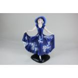 A Josef Lorenzl for Goldscheider Art Deco figure of a lady in blue hat and sun dress, 37cm, (a/f)