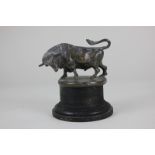 A small bronze model of a bull, on wooden base, 9.5cm high including base