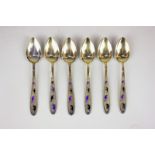 A set of six Russian silver gilt and enamel coffee spoons with foliate decorated handles, with