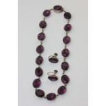 A Victorian silver mounted amethyst paste necklace and a pair of matching earrings