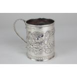 A Victorian Irish silver mug, cylindrical form with embossed floral decoration, engraved