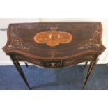 A French style inlaid mahogany card / games table with serpentine fold-over top inlaid with putti