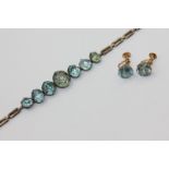 A blue zircon bracelet set with seven graduated stones, a pair of blue zircon ear studs on gold