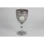 A Victorian silver goblet with banded embossed decoration of birds and foliage, vacant cartouche, on