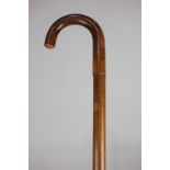 A 1930's malacca walking stick containing a black umbrella, 90cm