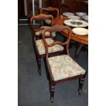 A set of four Victorian dining chairs, with open wavy backs, drop-in upholstered seats, on fluted