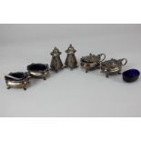 A George V silver six-piece cruet set of two mustards, two salts and two pepper pots, oval form with