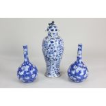 A Chinese blue and white porcelain baluster jar and cover with Fo dog finial, decorated with two