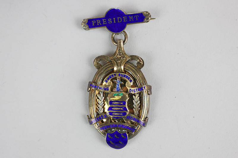 A George V silver gilt and enamel medal, The Worthing & West Sussex District Grocers & Provision