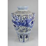 A blue and white glazed pottery vase, probably Chinese, of baluster form, decorated with storks,