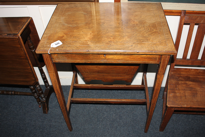 An inlaid rosewood sewing table with rectangular hinged lid enclosing a fitted interior and silks
