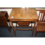 An inlaid rosewood sewing table with rectangular hinged lid enclosing a fitted interior and silks