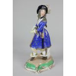 A 19th century unusual porcelain female figure wearing a cavalier's costume, 28.5cm, (a/f)