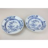 A pair of Chinese blue and white porcelain bowls decorated with chrysanthemums and other flowers,
