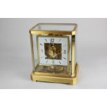 A Jaeger LeCoultre Atmos mantel clock, 12cm square dial in gilt metal framed glazed case, 23cm high