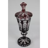 A cranberry flash cut glass urn with cover in lighter shade of red, 33cm high