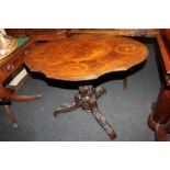 A 19th century burr wood tilt-top table, the shaped oval top decorated with panels