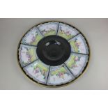 A Chinese black and gold lacquer circular hors d'oeuvre platter, the eight enamelled dishes