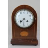 An Edwardian mahogany dome mantel clock the circular dial with Arabic numerals, the French