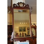 A Chippendale style fret cut wall mirror with gilt painted bird surmount, mirror plate 49.5cm by