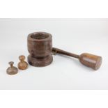 A small collection of treen, comprising a mortar, 12.5cm, two butter moulds and a pestle