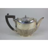 A George V silver bachelor's teapot, oval form with demi fluting, maker Mappin & Webb, Sheffield