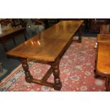 A 19th century large oak refectory table, on turned baluster legs with uniting stretcher