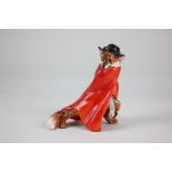 A Royal Doulton figure of a fox wearing a feathered cap and red cloak, stealing a chicken, HN1102,