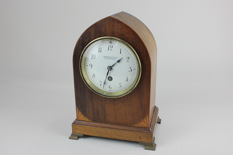 An Edwardian mahogany lancet shaped mantel clock white enamel dial, marked Camerer, Kuss & Co, 186
