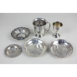 A George V silver christening cup, a silver egg cup, two silver dishes embossed with 'The Daily