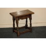 An oak stool with rectangular top on turned legs with low stretcher, 46cm