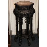 A Chinese rosewood jardiniere with marble top, carved and pierced with flowers, dragons and fish,