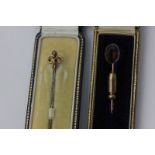 Two gold and gem set stick pins, in cases