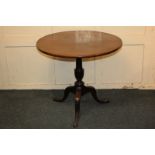 A 19th century circular mahogany tilt-top table on baluster turned stem and outswept tripod legs,