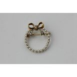 A pearl and diamond circlet brooch in yellow gold