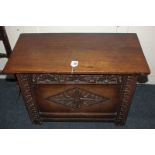 A small carved oak coffer, with diamond carved panelled front and rectangular hinged top, 69cm