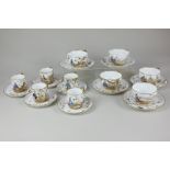 A porcelain part tea and coffee set decorated with Japanese figures amongst gilt floral and