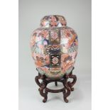 A large Chinese ginger jar and cover decorated in the Imari palette, with borders of flowers and