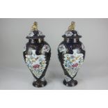 A pair of Chinese porcelain baluster jars and covers, each decorated with chrysanthemums within blue