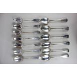 An assorted collection of thirteen 19th century silver tablespoons, including a set of four George