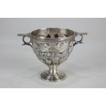 An Edward VII Art Nouveau two-handled cup, deeply embossed with trailing berries and foliage,