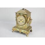 A French gilt metal mantel clock, circular dial with blue and white enamel cartouche numerals,