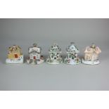 Five various Staffordshire pottery pastille burners modelled as cottages, to include a pair with