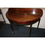 A 19th century mahogany demi-lune side table with raised gallery back, on tapered turned legs,