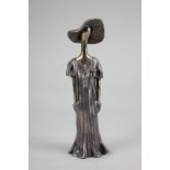 Ruth Bloch (born 1951, Israel), a silver plated sculpture of a woman wearing a sunhat and dress,