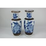 A pair of Chinese blue and white crackle glaze baluster vases depicting birds in foliage with