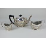An Edward VII three piece breakfast tea set of teapot, sugar bowl and cream jug, oval shape,