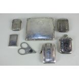 A silver plated cigarette case, five silver plated vesta cases, and a pair of silver plated cigar